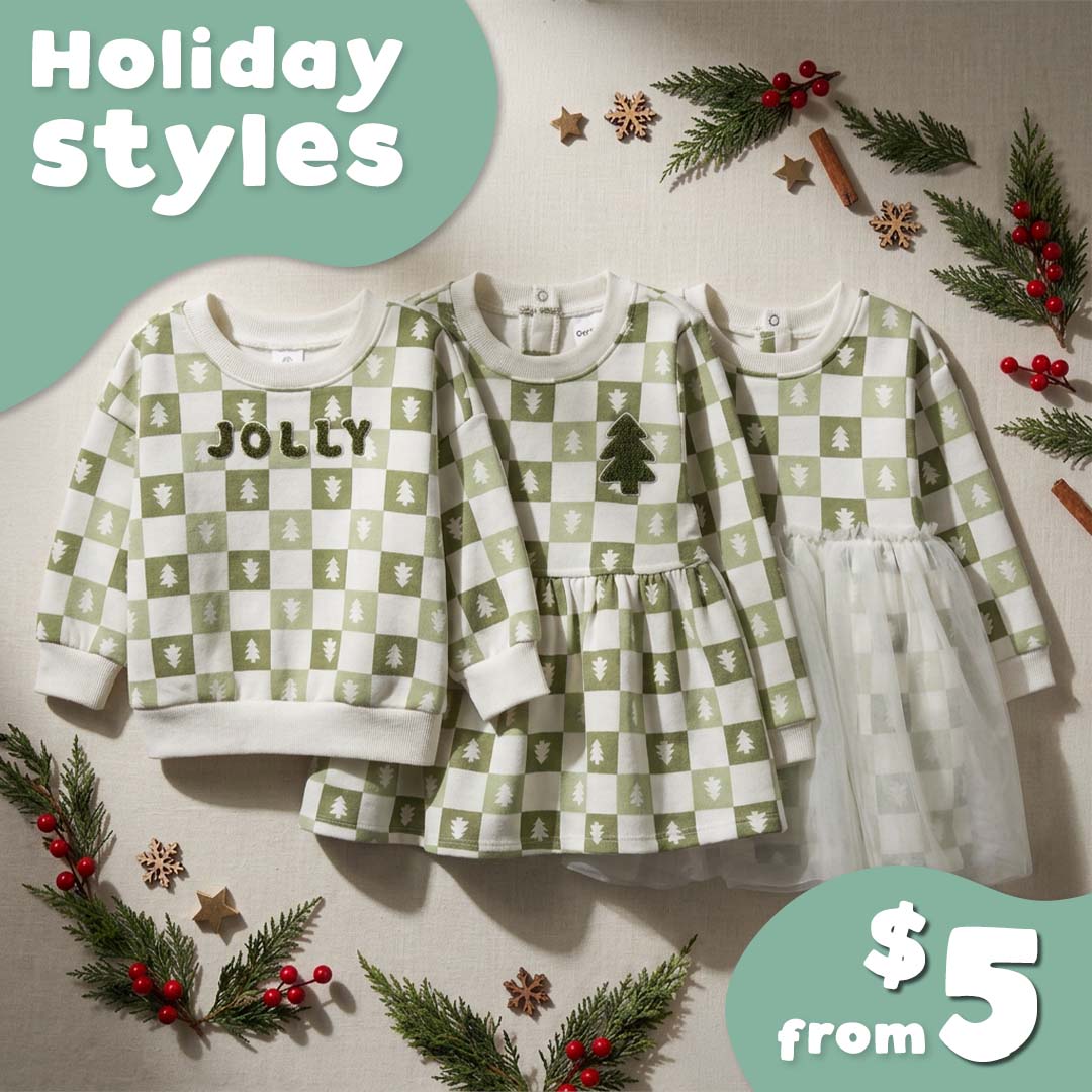 Three children's holiday-themed long-sleeve tops and dresses in a green and white checkered pattern are displayed on a beige fabric background decorated with pine branches, red berries, and wooden stars. A mint green circle in the top left reads 'Holiday styles' and a matching circle in the bottom right reads '$5 from'.
