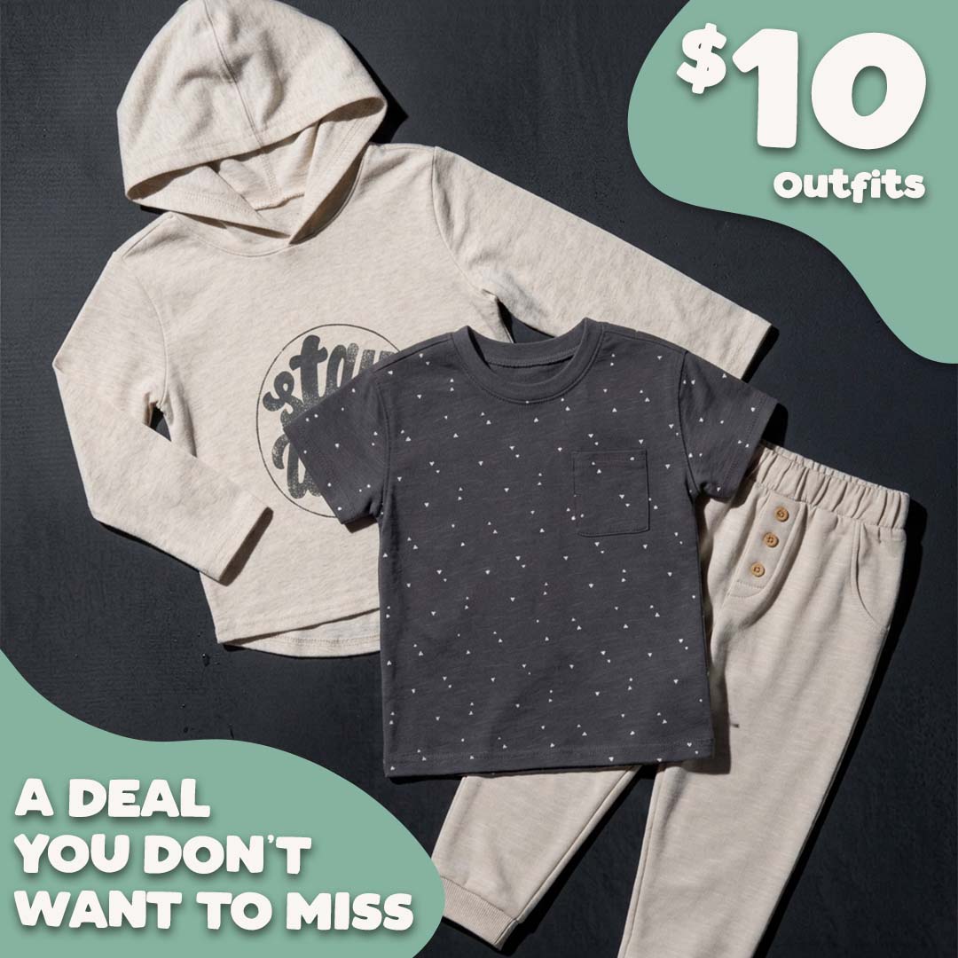 A children's three-piece outfit set laid flat on a dark background, featuring a light beige hooded sweatshirt with a graphic print, a dark charcoal gray short-sleeve t-shirt with tiny white dot patterns, and matching light beige pants with button details. Promotional text overlays read '$10 outfits' and 'A DEAL YOU DON'T WANT TO MISS'.