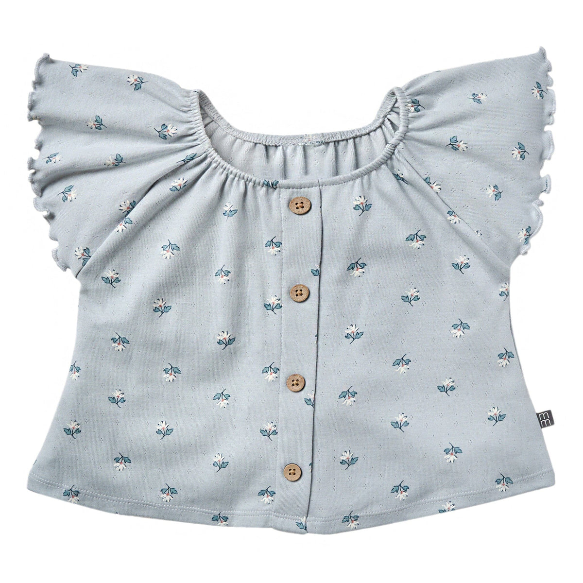 Light blue blouse with floral pattern and ruffled shoulders on a white background