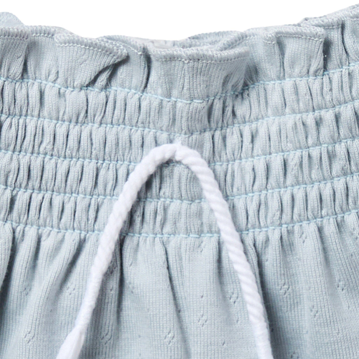 Close-up of light blue textured fabric with drawstring