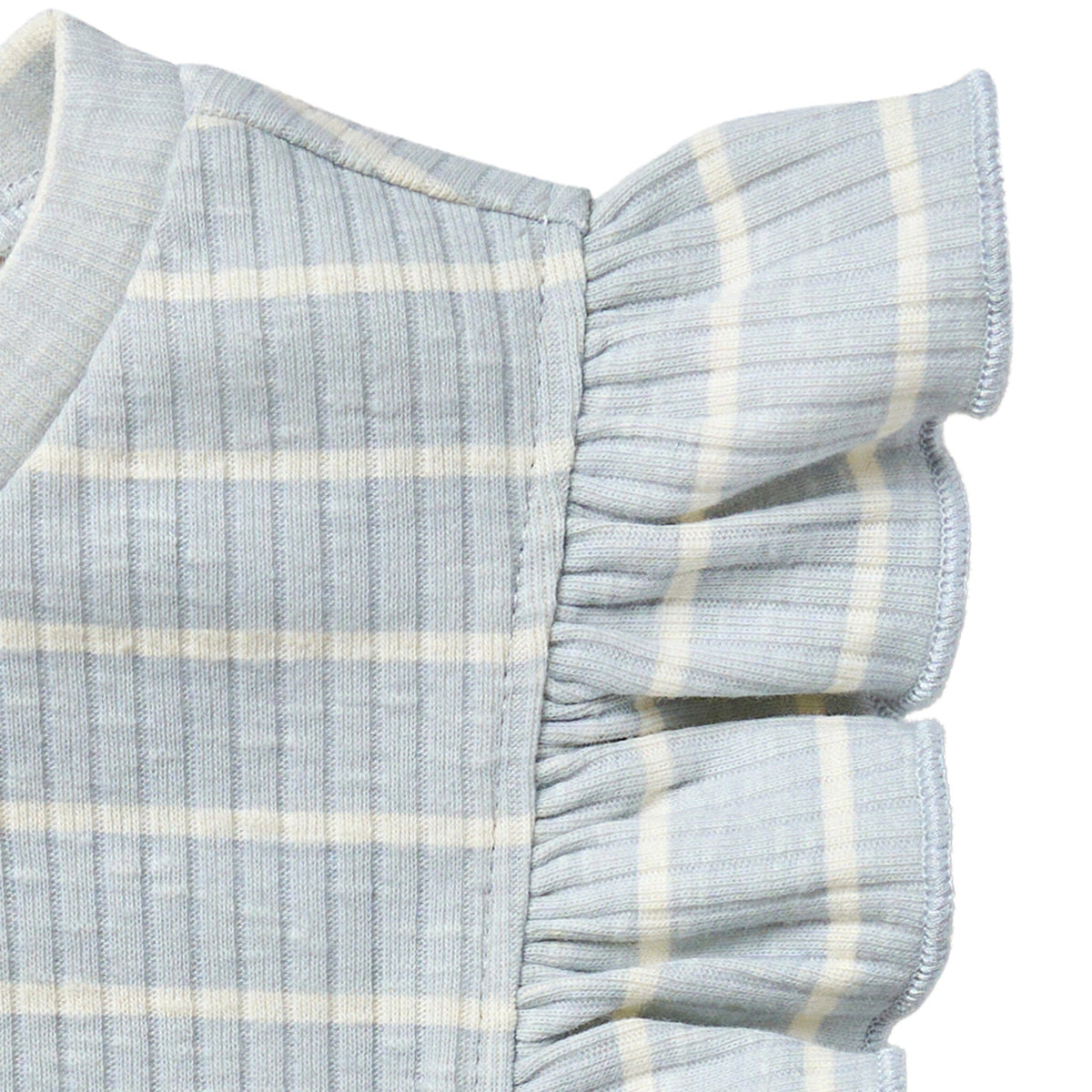 Close-up of a baby outfit with ruffled sleeves on a white background