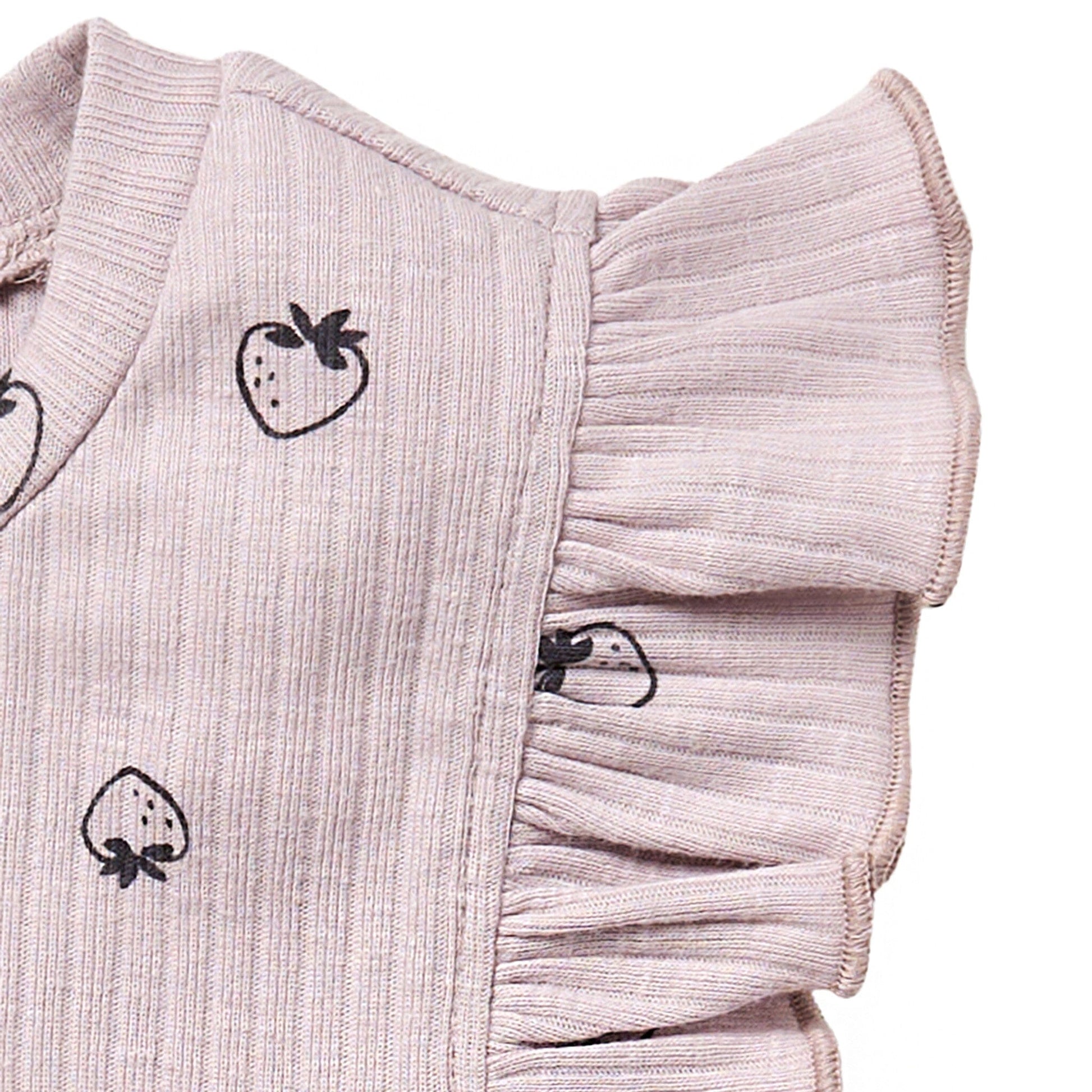 Pink textured fabric with black strawberry patterns on a white background