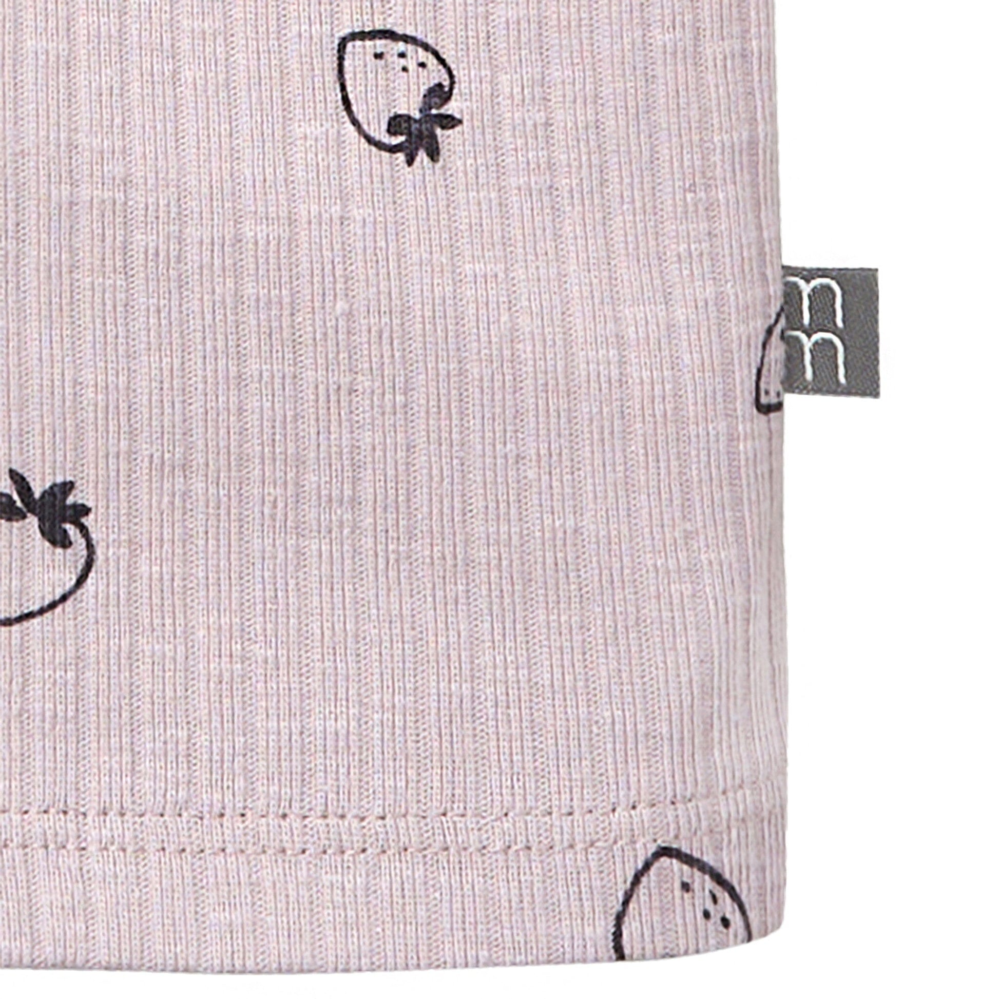 Close-up of a fabric with black strawberry pattern and a visible brand tag on a light gray background.