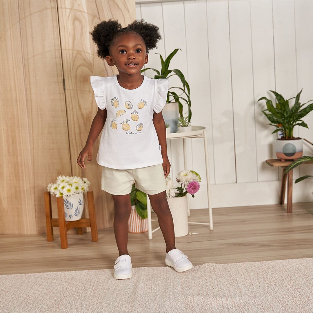 Toddler Girl posing in our collection of Gerber Childrenswear clothing and links to our collection of outfits and sets